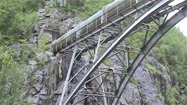 Why has this large pipe been laid across the rode on a bridge rather than being buried?  50.7 miles into the ride